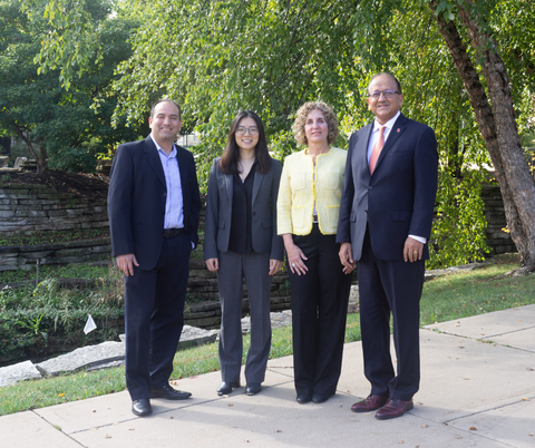 Photo of the research team standing side-by-side next to a stream