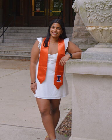 Ananya Singh stands, leaning on a statue, in front of the Noyes entrance. 