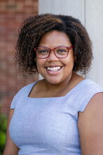 Portrait of Lauren outdoors with brick wall in background