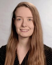 Head shot of Genny Korn on a tan background