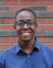 Portrait of William Ndugire in a brick background