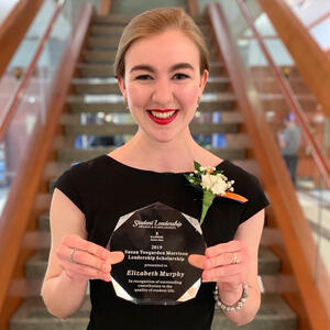 Elizabeth Murphy holding her Susan Teegarden Morrison Leadership Scholarship award