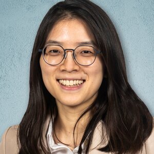 Head shot of Hee Sun Han on a blue background