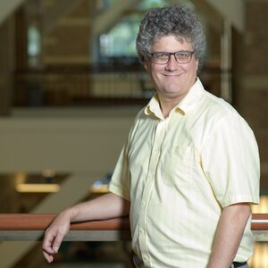 Portrait of Jonathan Sweedler standing at a railing in a building on the UIUC campus