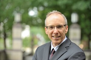 Head shot of Jeffrey Moore with a blurred background of an outdoor setting on campus