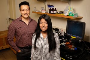 Portrait of professor Jeff Chan (left) standing next to Melissa Lucero in the lab. 