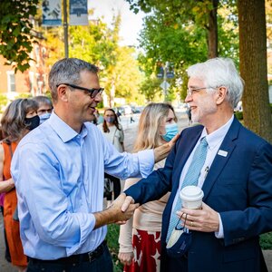 Photo of Martin Burke, left, shaking hands with University of Illinois System President Tim Killeen in front of the newly-dedicated MSB facility. 