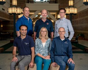 Photo of the EFRC research team members with three standing and three sitting in an atrium area of a campus building.