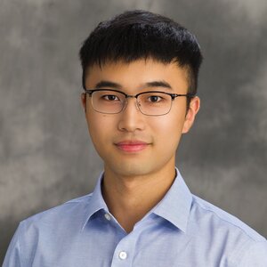 Head shot of Zhuang Xu on a light gray background.