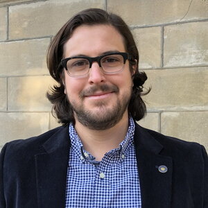 Head shot of Mikael Backlund in front of a stone wall 