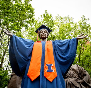 Alma Mater dressed in a cap and gown