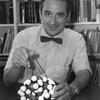 E.J. Corey pictured at his desk holding molecule model