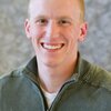 Head shot of graduate student Justin Miller on a gray background