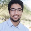 Head shot of Omar Alshangiti in a collared shirt with trees in the background 