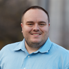 Head shot of Marshall Brennan in a light blue collared shirt 