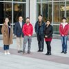 Photo of UIUC research team standing outdoors in front of a building on campus 
