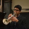 An image of Philip Kocheril playing a trumpet