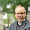 Head shot of Jeffrey Moore with a blurred background of an outdoor setting on campus