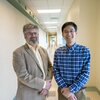 Jonathan Sweedler stands next to Fan Lam in a hallway on the Illinois campus.