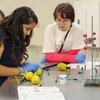 A graduate student leads a middle school student in a chemistry activity during the 2019 Day Camp for middle schoolers.