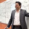Prashant Jain teaches class standing in front of a wipe off board in a Noyes classroom.