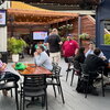 Event attendees sitting in chairs at tables in an outdoor venue