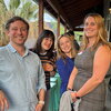 Four event stand together on a balcony at the outdoor venue