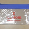Clear 7" x 4.5" vinyl zip bag with blue top band and white zipper. Block "I", Illinois wordmark and chemistry website (chemistry.illinois.edu) printed on front in orange. 